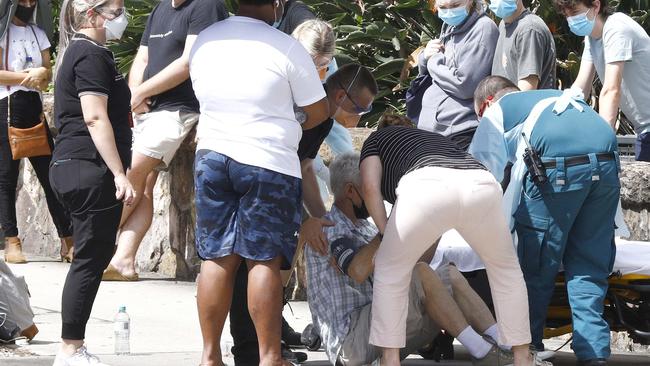 Paramedics tend to a person that fainted while in line for Covid testing at the Royal Women's Hospital in Brisbane. Picture: NCA NewsWire/Tertius Pickard