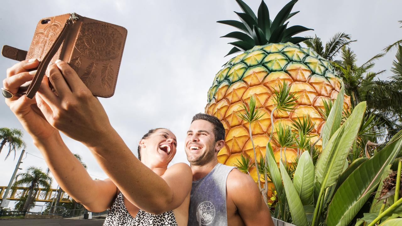 Yandell Davis and Pete Fenech stop by for a selfie at the Big Pineapple on their way for a surf at Mooloolaba. Picture: Lachie Millard