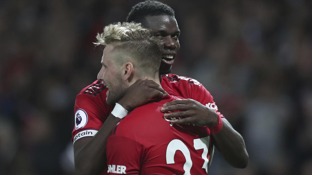Paul Pogba embraces fellow Manchester United goalscorer Luke Shaw. Picture: AP