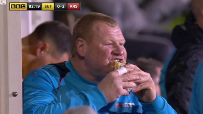 Wayne Shaw tucks into a pie during the FA Cup match against Arsenal.