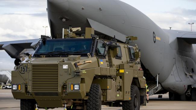 A Bushmaster protected mobility vehicle bound for Ukraine waits to be loaded onto a Royal Australian Air Force C-17A Globemaster.