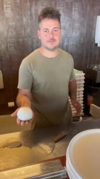 Owner of La Bella Italia Pizzeria Fabio Giardinelli preparing some freshly made pizza dough.