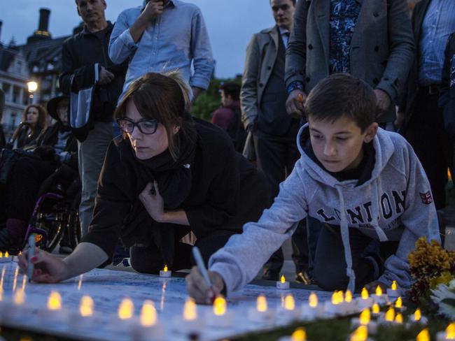 LONDON, UNITED KINGDOM - JUNE 16: People sign messages of condolence for MP Jo Cox during a vigil in Parliament Square on June 16, 2016 in London, United Kingdom. Jo Cox, 41, Labour MP for Batley and Spen, was shot and stabbed by an attacker at her constituicency today in Birstall, England. A man also suffered slight injuries during the attack. Jo Cox was reportedly shot and stabbed while holding her weekly surgery at Birstall Library, Birstall near Leeds and later diedl. A 52-year old man has been arrested in connection with the crime. (Photo by Dan Kitwood/Getty Images)