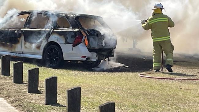 Fire crews work to douse the flames after a fiery crash in Archerfield.