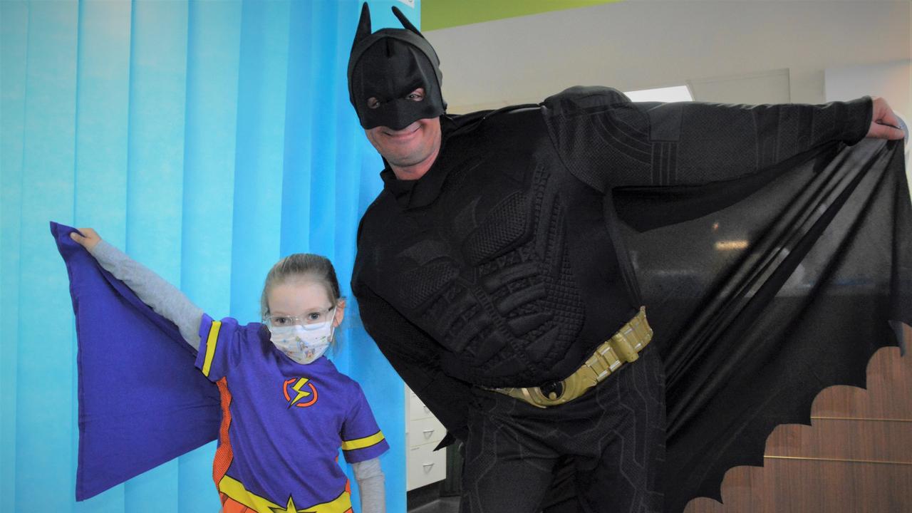 SUPERHEROES: Molly Schmidt received her very own Supertee today from Batman (Paul Wilson) thanks to a generous donation from Toowoomba City Rotary Club. Pictures: Kate McCormack