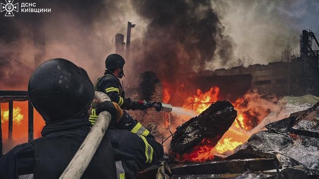 Firefighters extinguish fire following a Russian strike in Brovary, near Kyiv, on November 13. Picture: State Emergency Service of Ukraine/AFP