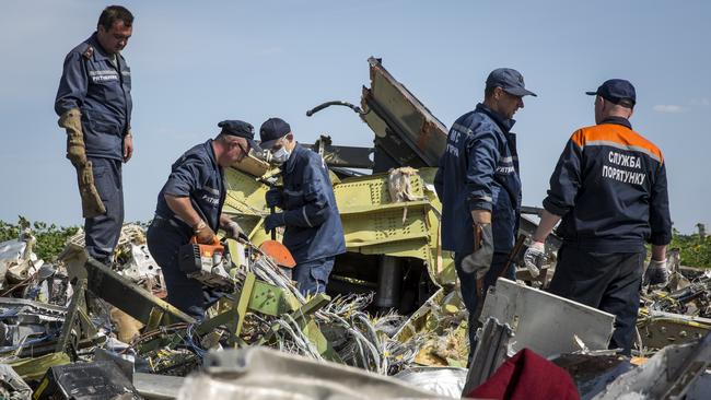 Ukrainian rescue servicemen inspect the wreckage of Malaysia Airlines flight MH17 on July 20, 2014 in Rassipnoye, Ukraine.