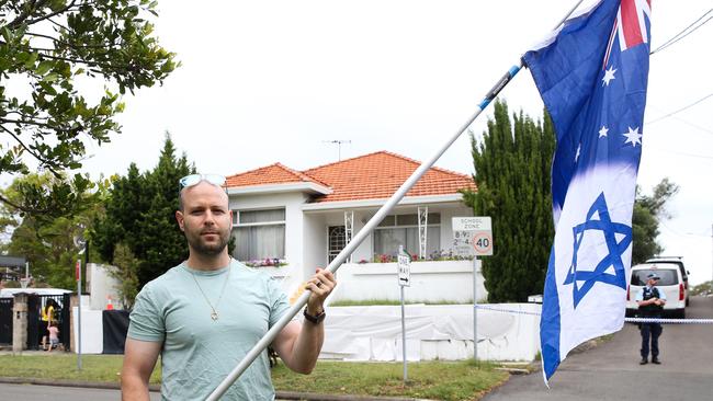 Ofir Birenbaum carries a flag as he arrives at Mount Sinai College in Maroubra. Picture: NewsWire/ Gaye Gerard