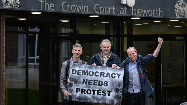 Dr Larch Maxey (L), Co-Founder of Just Stop Oil Roger Hallam (C) and Mike Lynch-White (R) pose for photographs as they leave Isleworth Crown Court following sentencing on charges of causing a public nuisance during environmental protests in April. Picture: Leon Neal/Getty Images