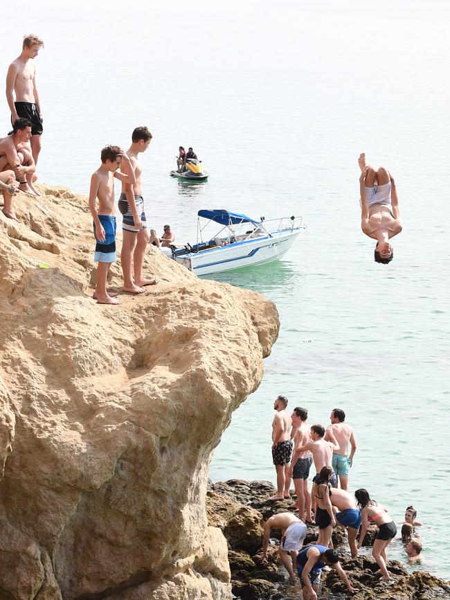 A diver jumps into the bay at The Pillars. Picture: Jason Sammon