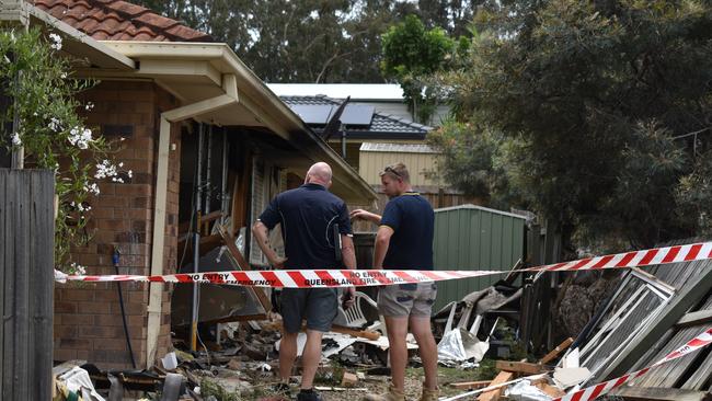 Builders inspect the damage to a Bloodwood Place home after a Porsche crashed into a bedroom this morning, Wednesday morning, November 23. Picture: Peta McEachern