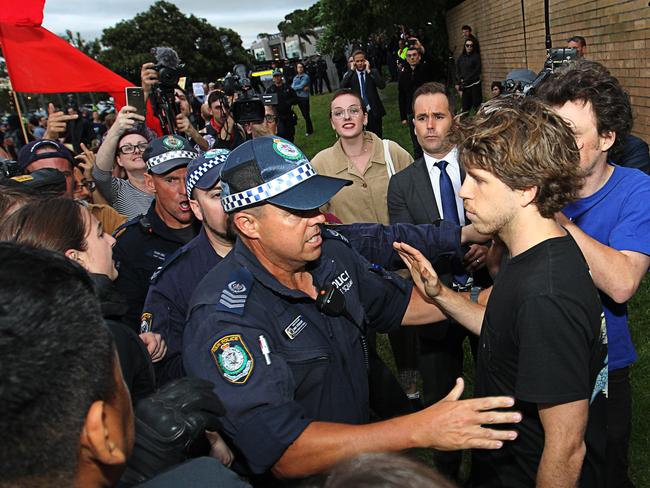 A supporter of British alt-right commentator Milo Yiannopoulos is escorted by police during clashes with left-wing protesters in Lilyfield, Sydney. Picture: AAP Image/Danny Casey