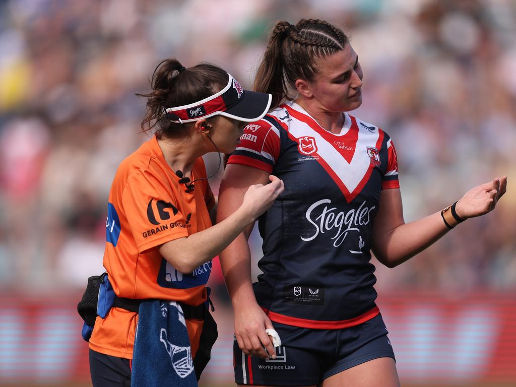 Julia Robinson (centre) of the Broncos is tackled by Holli Wheeler (left)  and Jessica Sergis (right) of the Dragons during the NRL Women's  Premiership match between the Brisbane Broncos and the St