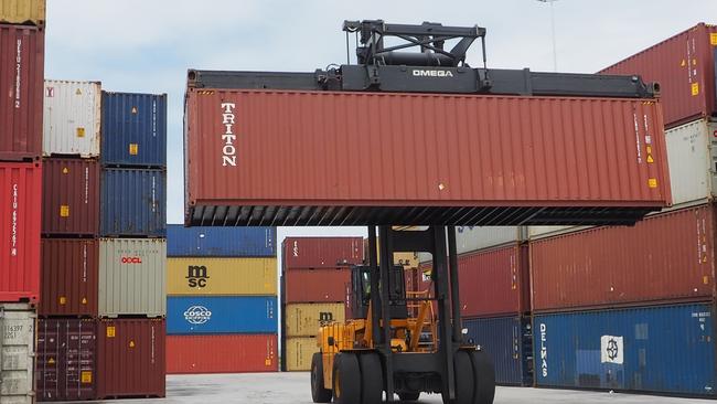 Shipping containers being moved at the Port of Brisbane.