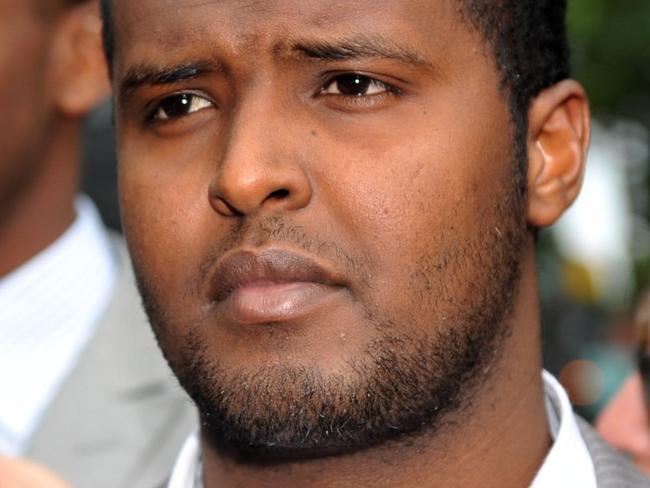 Yacqub Khayre (centre) and Abdirahman Amend leave court in Melbourne, Thursday, Dec. 23, 2010. The two men were acquitted by a Supreme Court jury, of planning an alleged terrorist attack on the Holsworthy army base in Sydney, while the other three co-accused were found guilty. (AAP Image/Julian Smith) NO ARCHIVING