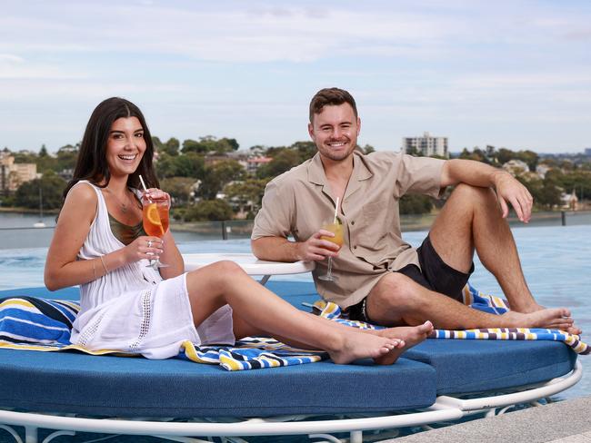 Staycationers Haley Evirgen and Will McLoughlin, at Crown Sydney Pool. Picture: Justin Lloyd.