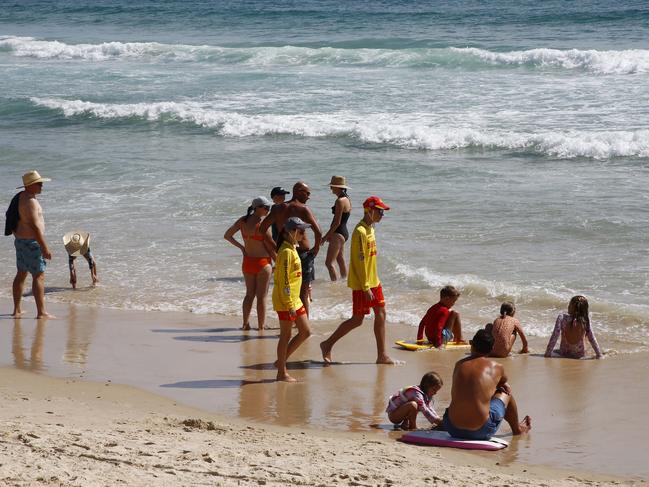 Hundreds of people flocked to the beaches to celebrate Australia Day. Lifeguards ordered swimmers out of the water after a shark was spotted at Burleigh beach. Picture: Tertius Pickard