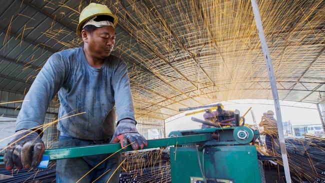 Steel bars being cut in Jiangsu province, China. Picture: Reuters