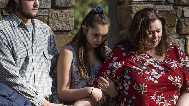 Drew and Seisia Myler hold the hand of their mother, Gaye Myler, during a minute's silence memorial service at Port Arthur, Tasmania, on Wednesday. Picture: Luke Bowden/ABC News