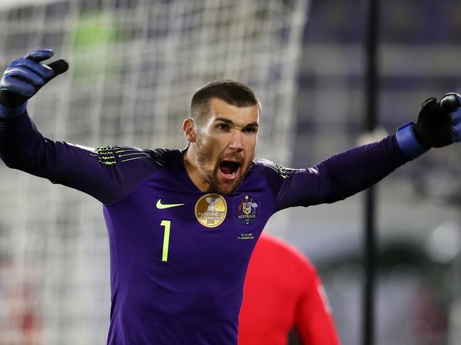 AL AIN, UNITED ARAB EMIRATES - JANUARY 21: Mat Ryan of Australia celebrates after saving the fourth penalty from Marat Bikmaev of Uzbekistan (not pictured) in the penalty shoot out during the AFC Asian Cup round of 16 match between Australia and Uzbekistan at Khalifa Bin Zayed Stadium on January 21, 2019 in Al Ain, United Arab Emirates. (Photo by Francois Nel/Getty Images)