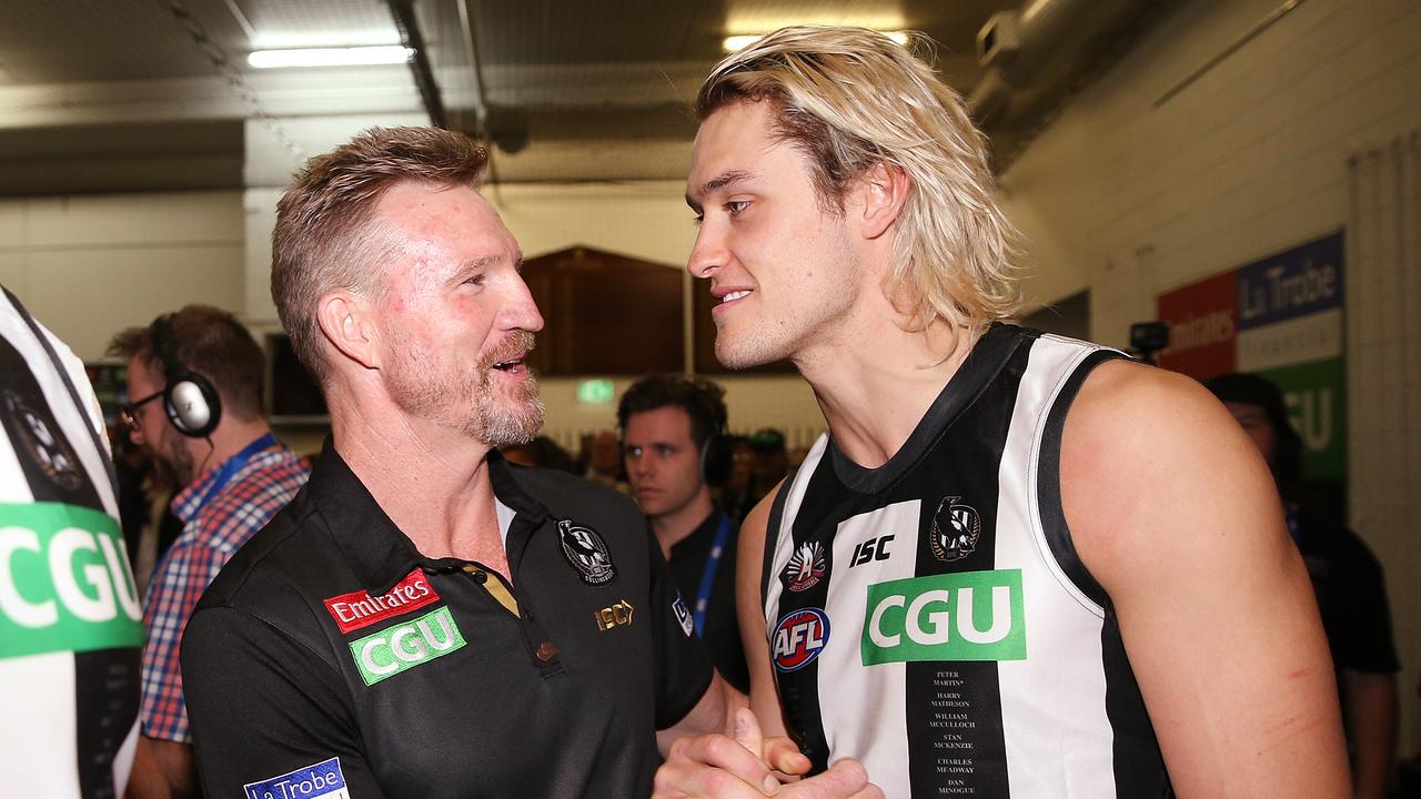 MELBOURNE, AUSTRALIA - APRIL 25: Magpies head coach Nathan Buckley celebrates the win with Darcy Moore of the Magpies during the round 6 AFL match between Essendon and Collingwood at Melbourne Cricket Ground on April 25, 2019 in Melbourne, Australia. (Photo by Michael Dodge/Getty Images)