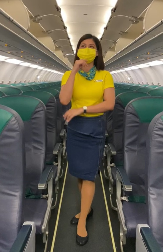 Henny Joyce Lim, a flight attendant for Philippines-based airline Cebu Pacific, has revealed the true meaning behind the tiny triangle stickers above plane windows. Picture: TikTok/_hennylim