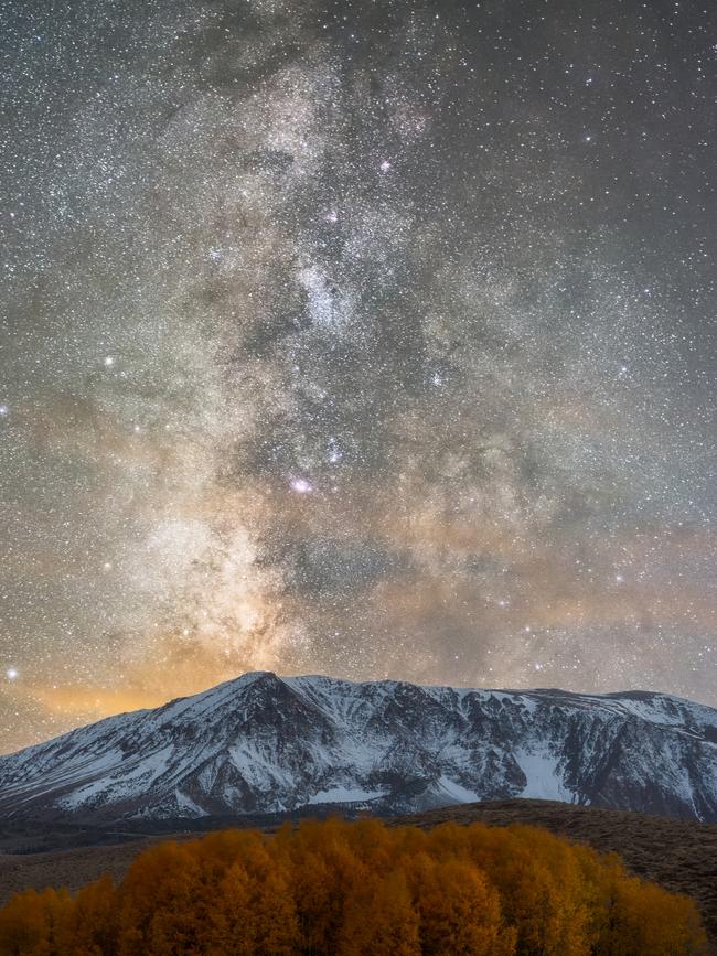 Insight Astronomy Photographer of the Year 2017 shortlist selection: Fall Milk . Picture: Brandon Yoshizawa (USA) The snow-clad mountain in the Eastern Sierras towers over the rusty aspen grove aligned perfectly in front of it, whilst our galaxy the Milky Way glistens above. Eastern Sierras, California, USA, 21 October 2016