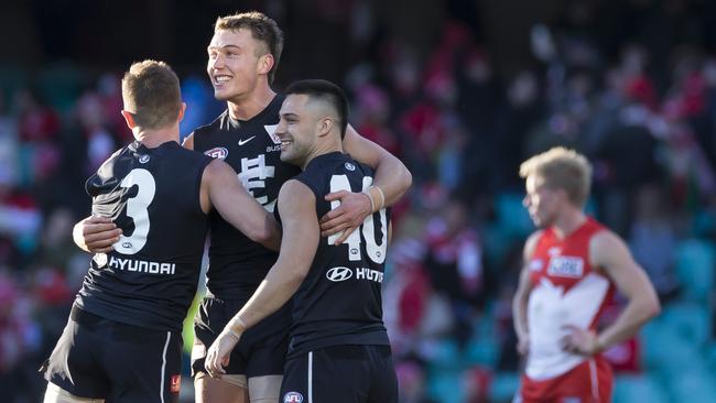 Marc Murphy, Patrick Cripps and Michael Gibbons celebrate Carlton’s win. Picture: AAP Image/Craig Golding.