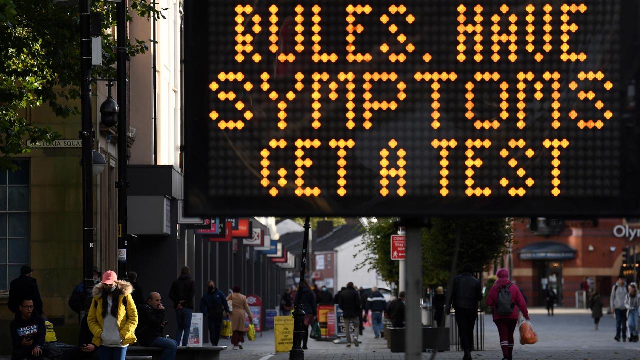 An electronic road sign in Bolton, northwest England, where cases have begun to rise. (Photo by Oli SCARFF / AFP)