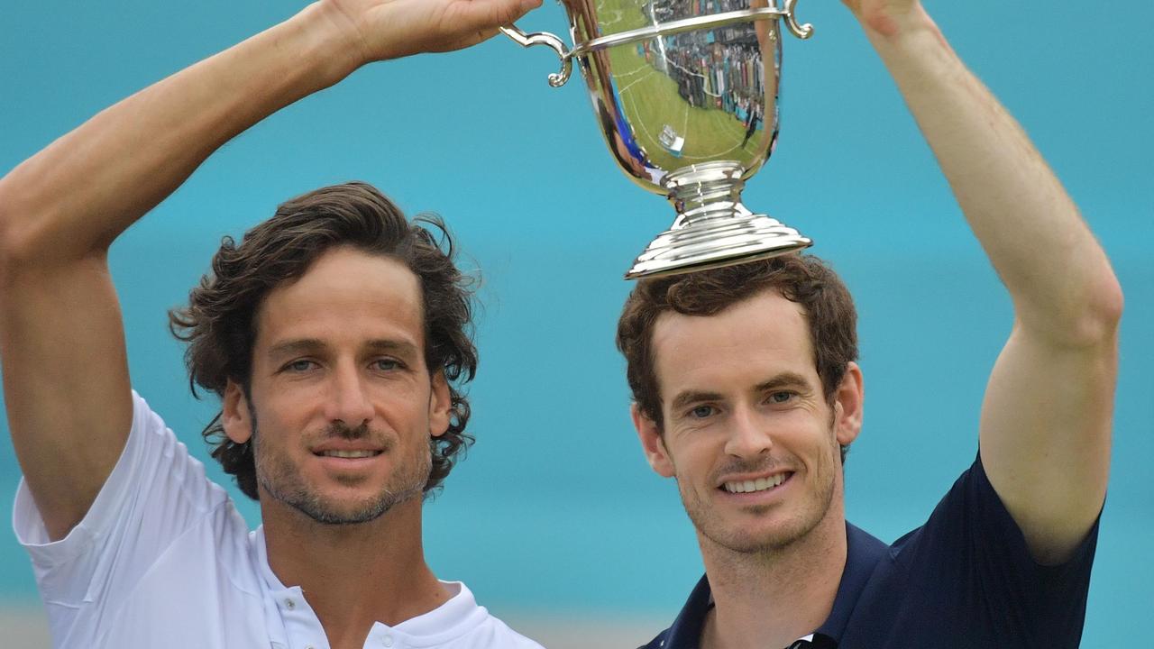 Britain's Andy Murray (R) and Spain's Feliciano Lopez pose with the trophy after their win in the men's doubles final tennis match against US player Rajeev Ram and Britain's Joe Salisbury at the ATP Fever-Tree Championships tournament at Queen's Club in west London on June 23, 2019. (Photo by Daniel LEAL-OLIVAS / AFP)