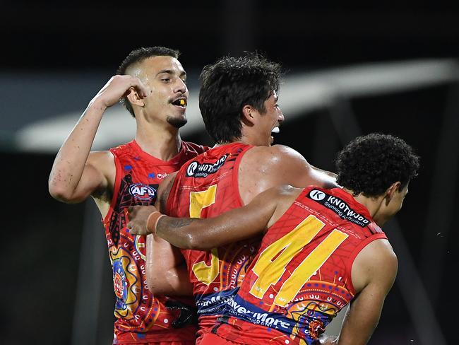 Joel Jeffrey, Alex Davies and Malcolm Rosas Jr celebrate one of 15 goals for the Suns. (Photo by Felicity Elliott/AFL Photos via Getty Images)