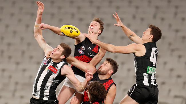 Collingwood’s Mason Cox (left) struggled against Essendon in the wet on Friday night. Picture: Getty Images