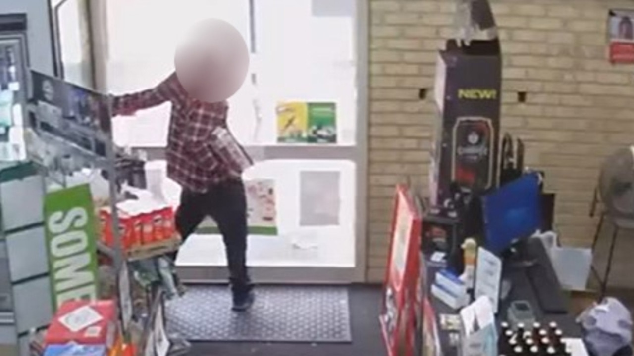 A man has been caught on CCTV trying to run off with a box of drinks from a bottle-o before becoming stuck in the store. Picture: Facebook