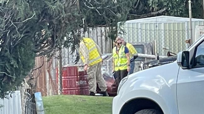 Workplace Health and Safety officers examine the site where a man in his 20s was critically injured in a small explosion.