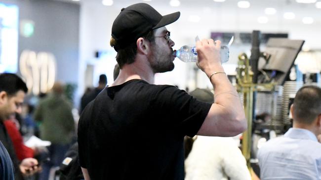 The Hollywood star flashed his muscles as he smiled at fans in the airport. Picture: Backgrid