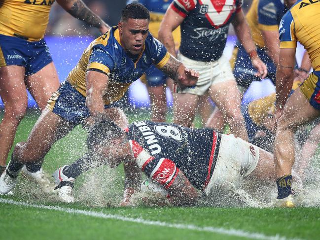 Roosters prop Spencer Leniu splashes around in the wet at Allianz Stadium. Credit: NRL Images.