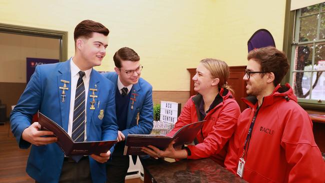 Patrician Brothers Collage students Flynn Broom and Anthony Simic poses for photographs with ACU Future Students Officers in June 2020 (AAP IMAGE / Angelo Velardo)