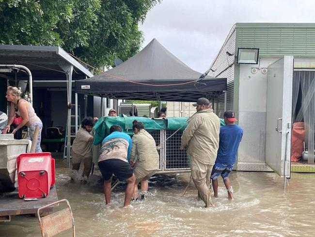 Burketown residents load vehicles with belongings as floodwaters rise.