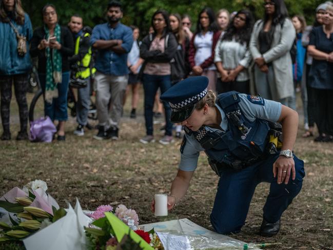  A police officer places a candle among flowers and tributes near Al Noor mosque. Picture: Getty 