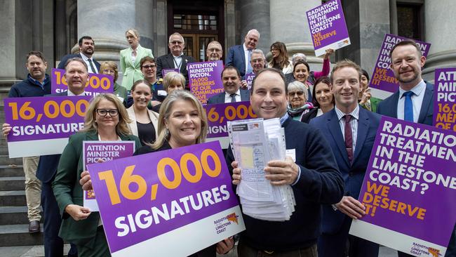 Deanne Carmody and Lachlan Haynes, the chair of The Radiation Working Group Limestone Coast, and Leader of the Opposition David Speirs out front of Parliament House with the 16,000 signatures for a South-East radiation treatment centre. Picture; Mark Brake