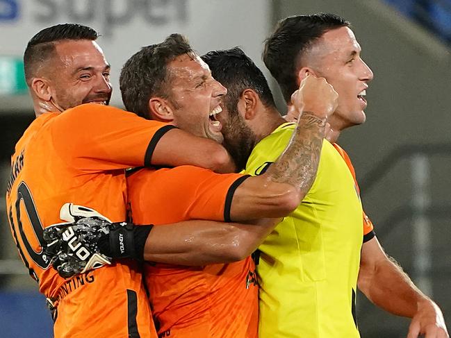 Scott McDonald of the Roar (centre) celebrates after scoring a goal during the Round 24 A-League match between Brisbane Roar and Newcastle Jets at CBus Super Stadium on the Gold Coast, Friday, March 20, 2020. (AAP Image/Dave Hunt) NO ARCHIVING, EDITORIAL USE ONLY