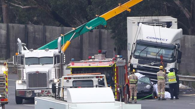 A crane is used to lift the truck off the Porsche. Picture: David Crosling