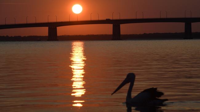 The sun rises over Captain Cook Bridge as Sydneysiders head toward a hot weekend. Picture: AAP Image/Dean Lewins.