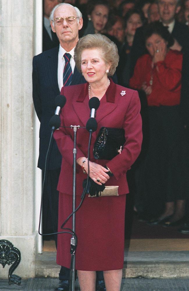 Former British Prime Minister Margaret Thatcher flanked by her husband Denis. She is pictured here addressing the press in November 1990 for the last time in front of 10 Downing Street prior to her resignation as prime minister. Picture: AFP