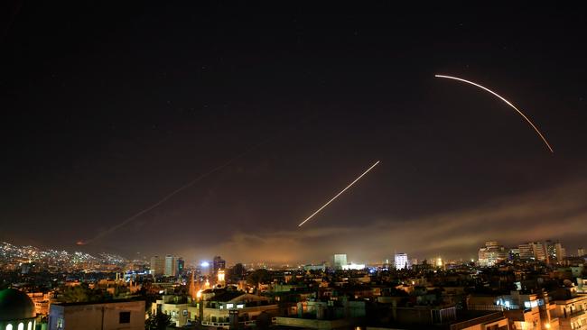 Missiles streak across the Damascus skyline as the US. launches an attack on Syria targeting different parts of the capital. Picture: AP /Hassan Ammar.