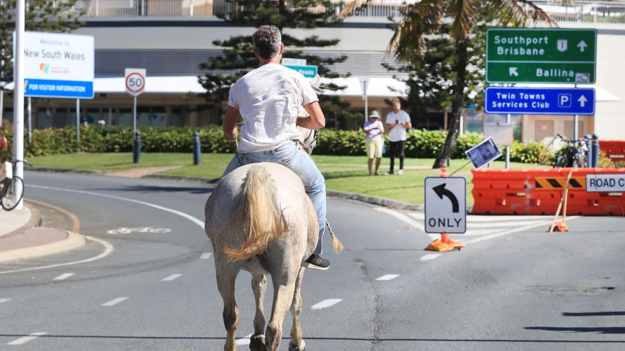 Michael Corrigan protests against lockdowns at Coolangatta. Picture: NCA Newswire / Scott Powick