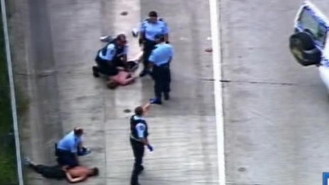 Police arrest the men after the dramatic chase came to an end at Tweed Heads. Image: Channel 7