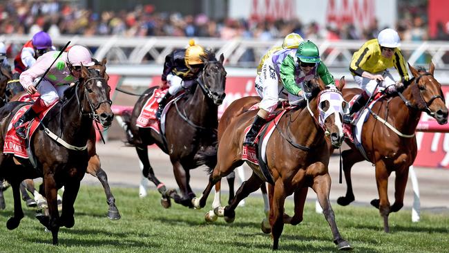 Jockey Michelle Payne (centre) riding Prince Of Penzance crosses the finish line to win the $6,000,000 Melbourne Cup race at Flemington Racecourse in Melbourne, on Tuesday, Nov. 3, 2015.(AAP Image/Julian Smith) NO ARCHIVING, EDITORIAL USE ONLY