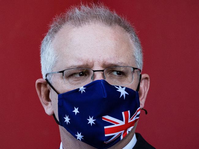 MELBOURNE, AUSTRALIA - NOVEMBER 16: Prime Minister Scott Morrison looks on during a press conference at CSL Lab where a COVID-19 Vaccine is being produced on November 16, 2020 in Melbourne, Australia. The federal government has announced a $1.8 billion agreement with pharmaceutical company CSL to construct a new biotech and vaccine manufacturing plant in Melbourne. The plant - to be the largest in the southern hemisphere - will deliver the first population-wide pandemic and seasonal flu vaccines for Australians, safeguarding the nation from global supply chain shortages or queues. (Photo by Darrian Traynor/Getty Images)