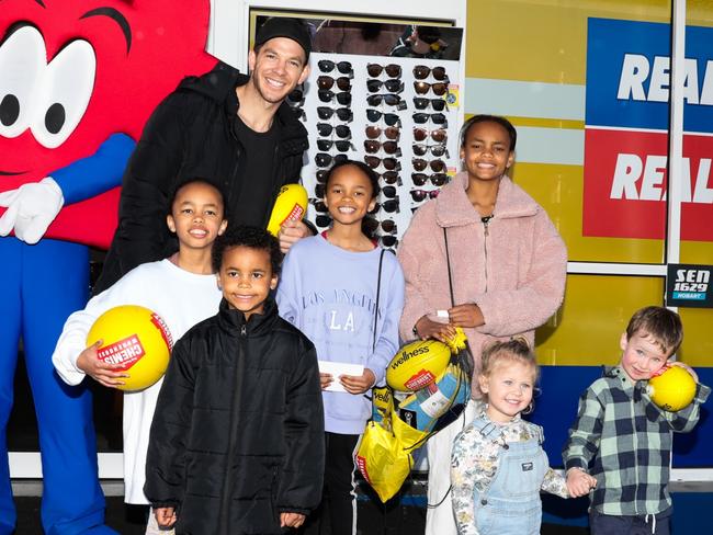 Tim Paine meets young fans, from left, Victoria, 8, Ian, 6, Connie, 9, Christina, 11, Lucy, 2, and Hamish, 4, in North Hobart on Saturday. Picture: Mireille Merlet